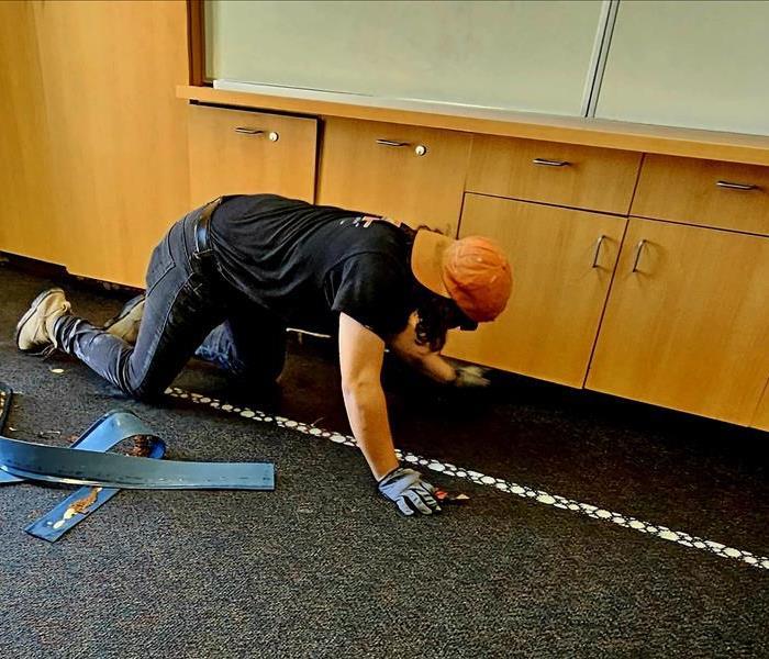 Servpro team marching into a flooded classroom