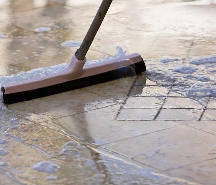 sweeping up a water spill